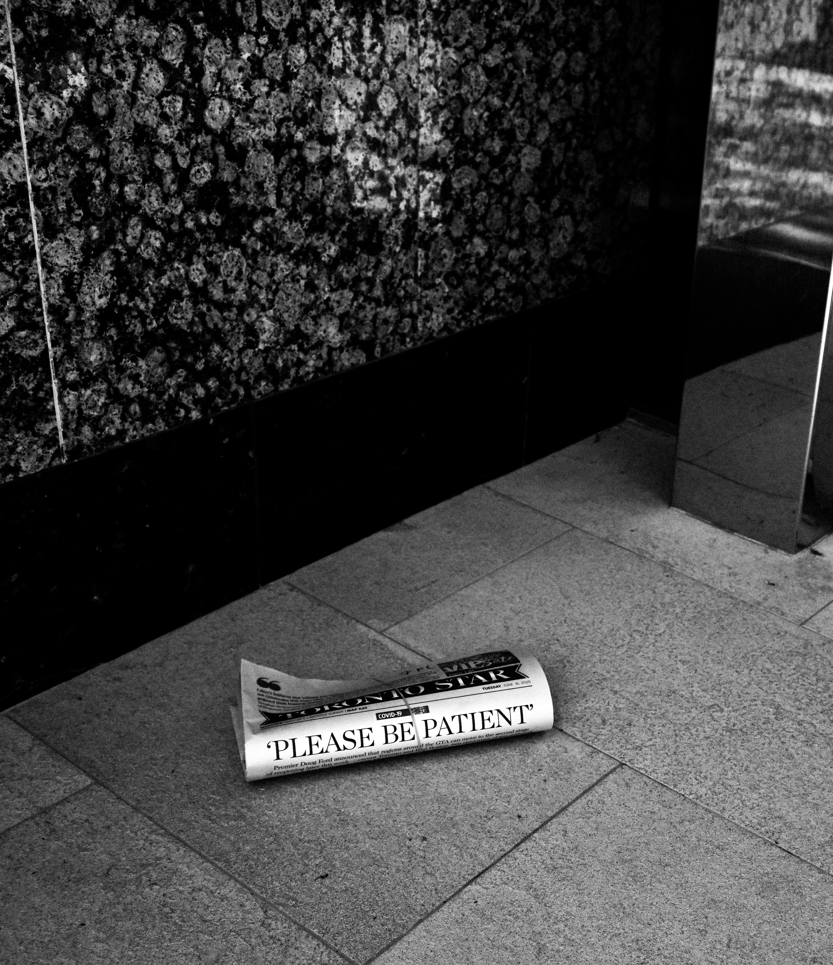 Rolled newspaper on the floor, conceptual still life