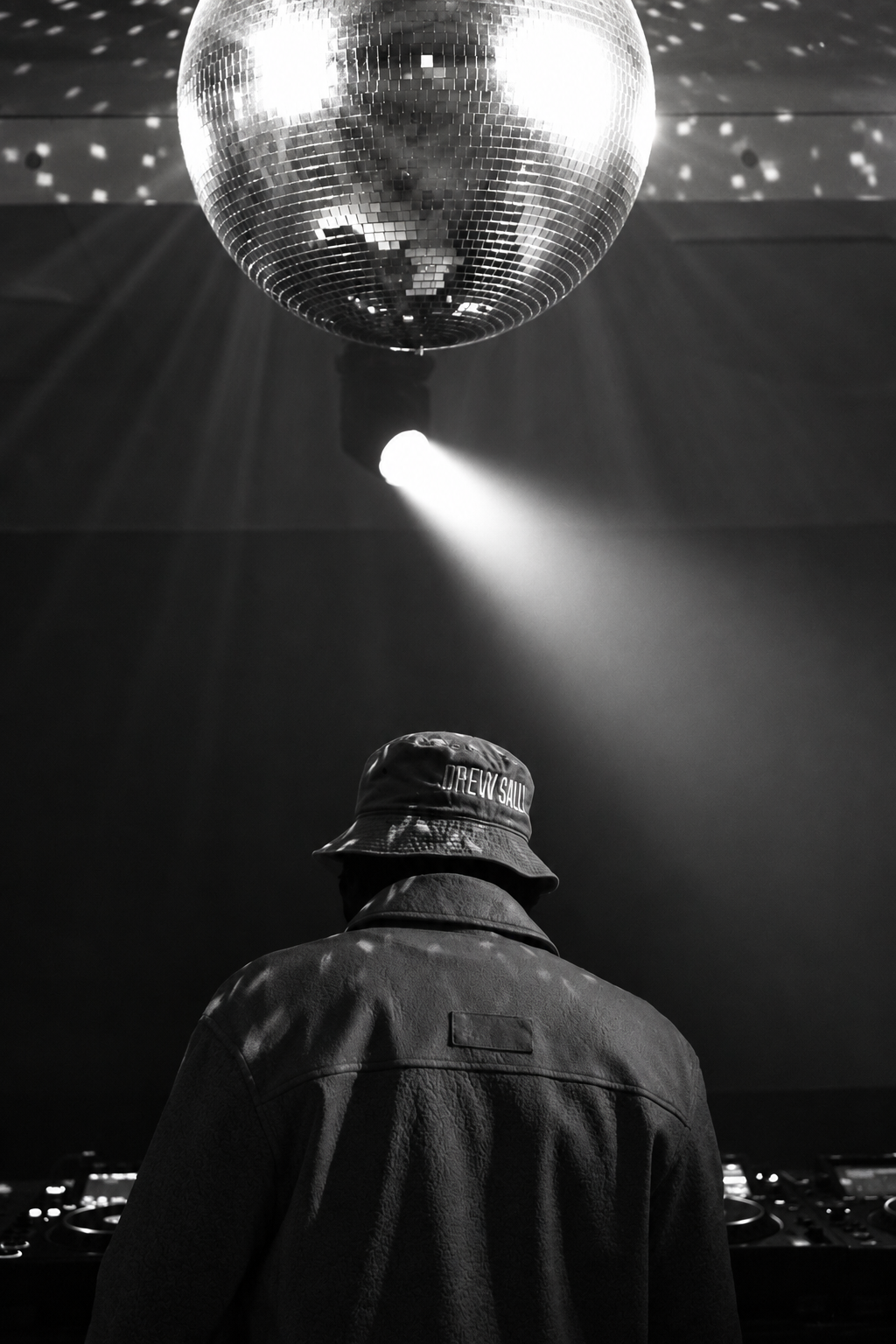 Person gazing at a disco ball in a spotlight, event portrait